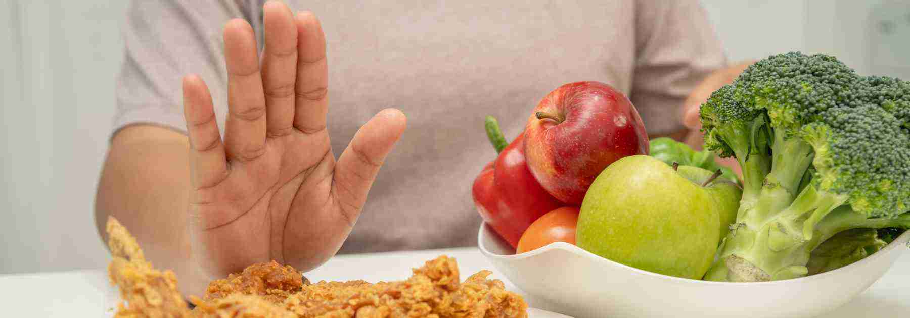 Man rejecting food to help lose weight