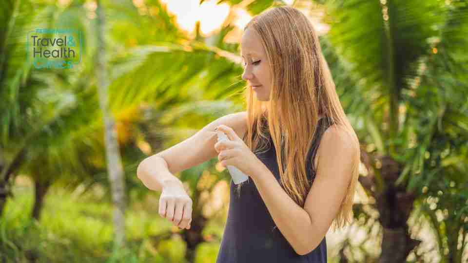 Woman using mosquito insect repellent